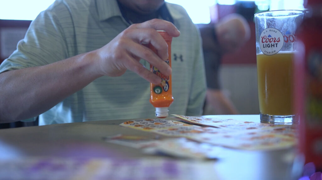 Man playing bingo with a dauber in hand at The Dog House Bar and Grill in Maplewood. MN